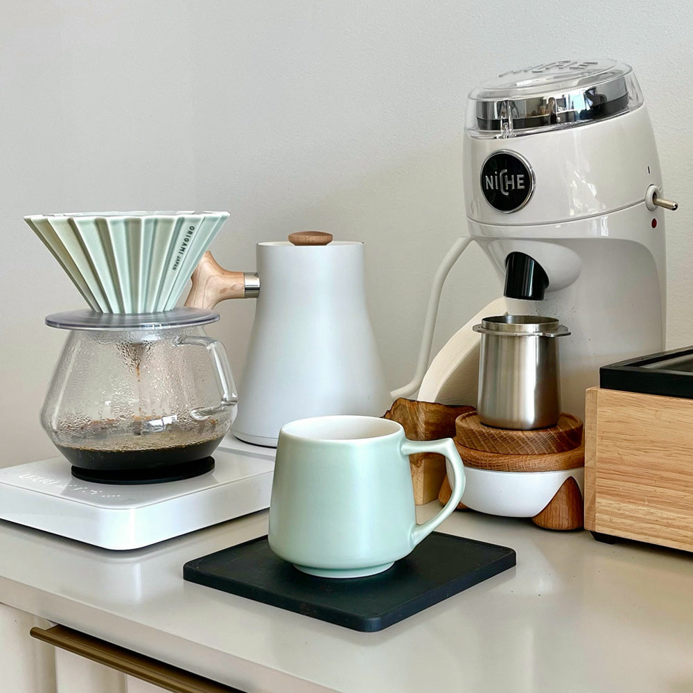 White Niche Zero next to brewing filter coffee on scales